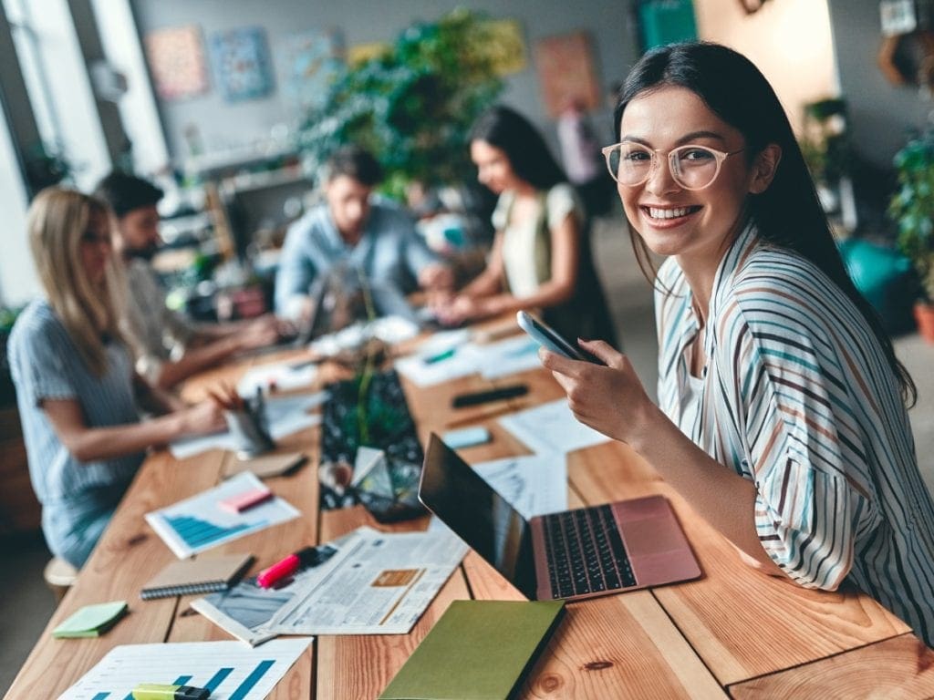 Woman working on laptop at community table