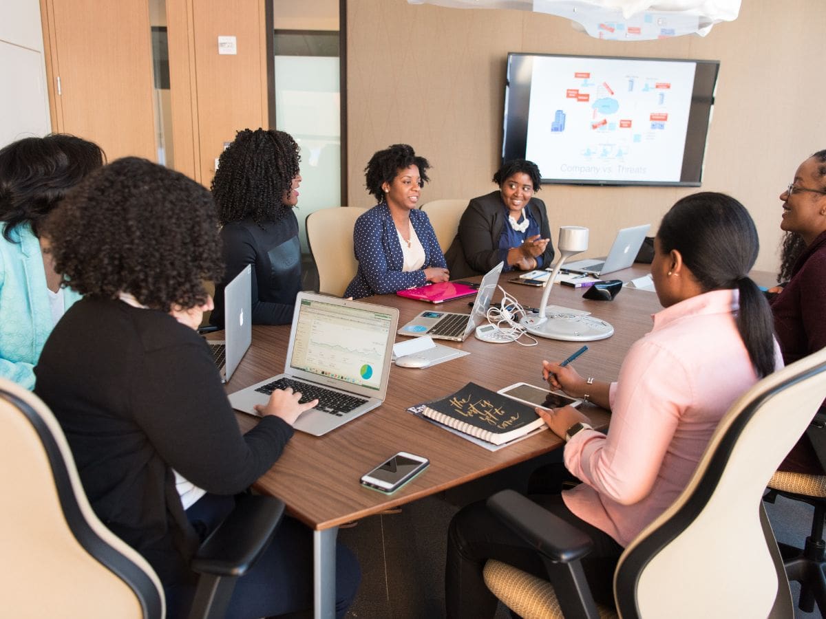 Group of men and women with laptops around a conference table. Name of the program: Environmental Marketing and Behavioral Economics Degree level: Master of Professional Studies