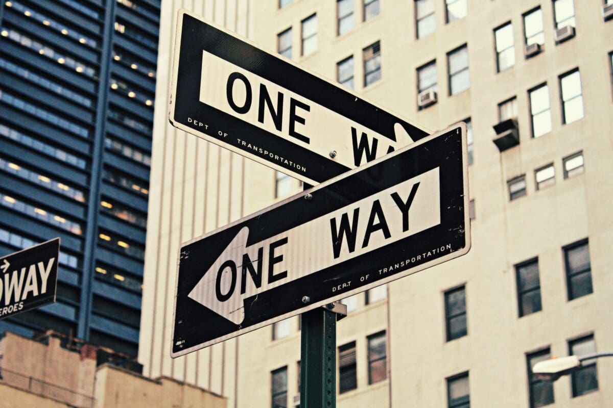 two one way signs that represent different career paths