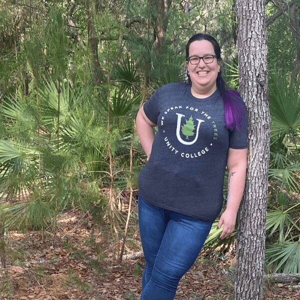 DE Ambassador Catherine leans against a tree.