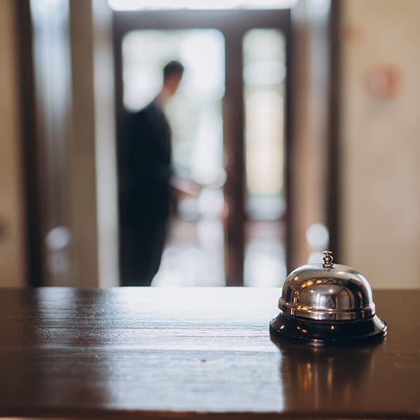 Arrival at the hotel. Reception desk with a bell in the hotel lobby.