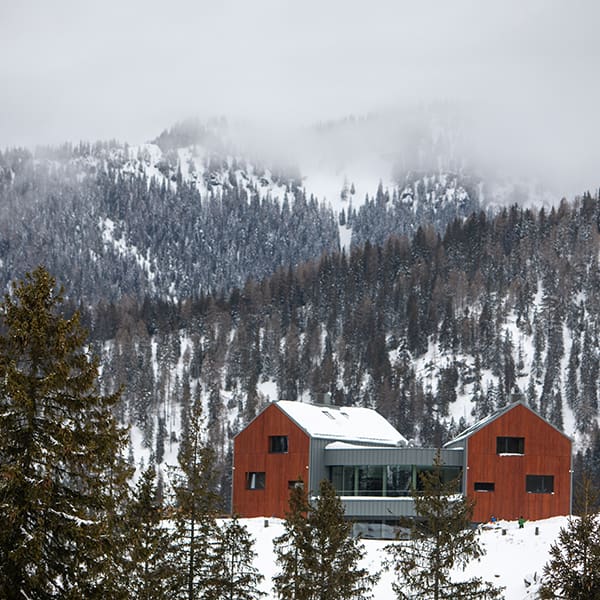 Building in winter mountains copy space.