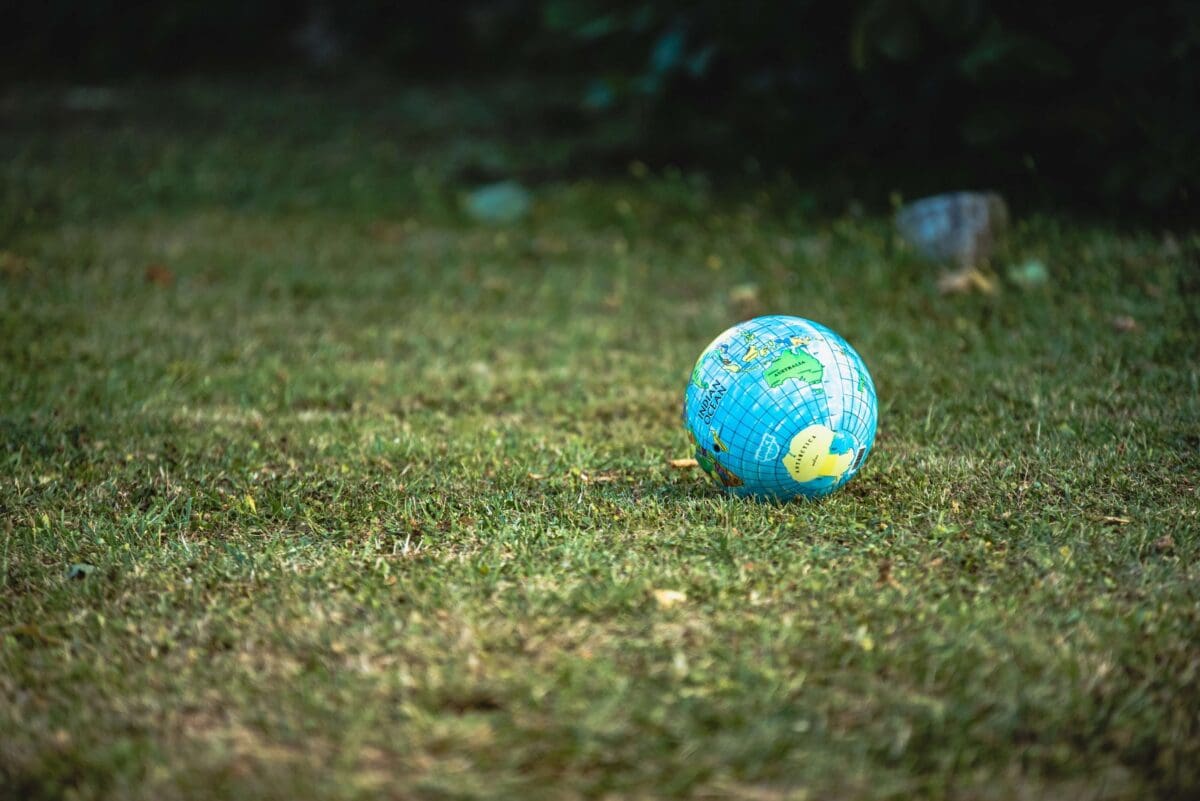 a globe resting on a field of grass