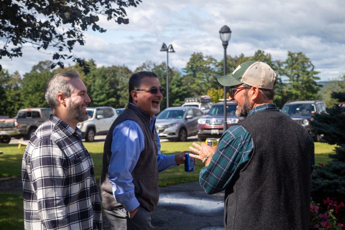 Dr. Melik Khoury and two other faculty members joke around at the faculty BBQ.
