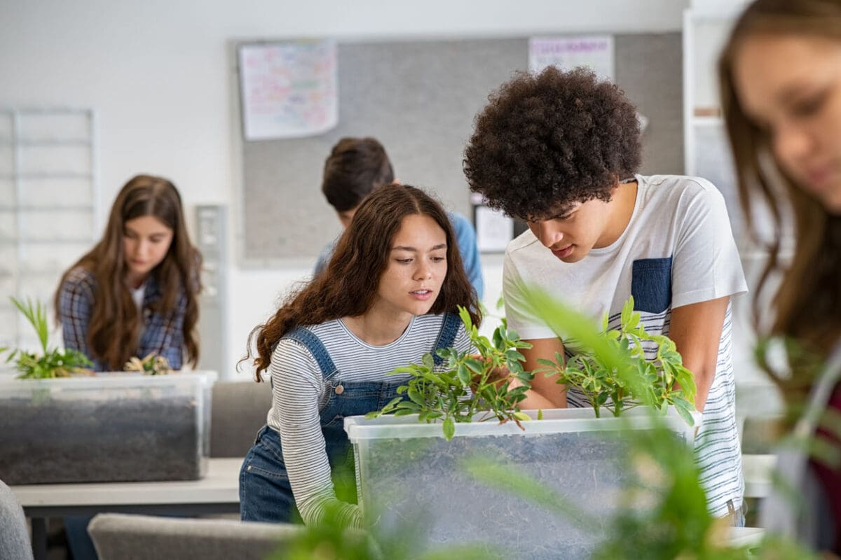 two students studying a plant in a lab as a form of experiential learning