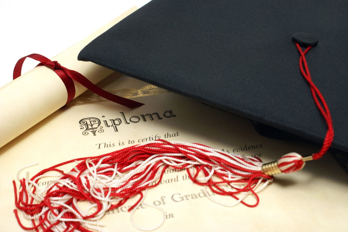 a graduation cap sitting on top of a university diploma