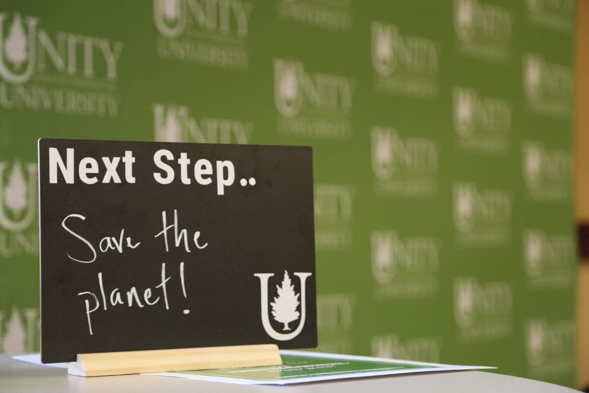 Sign on a table that reads, "Save the Planet". 
