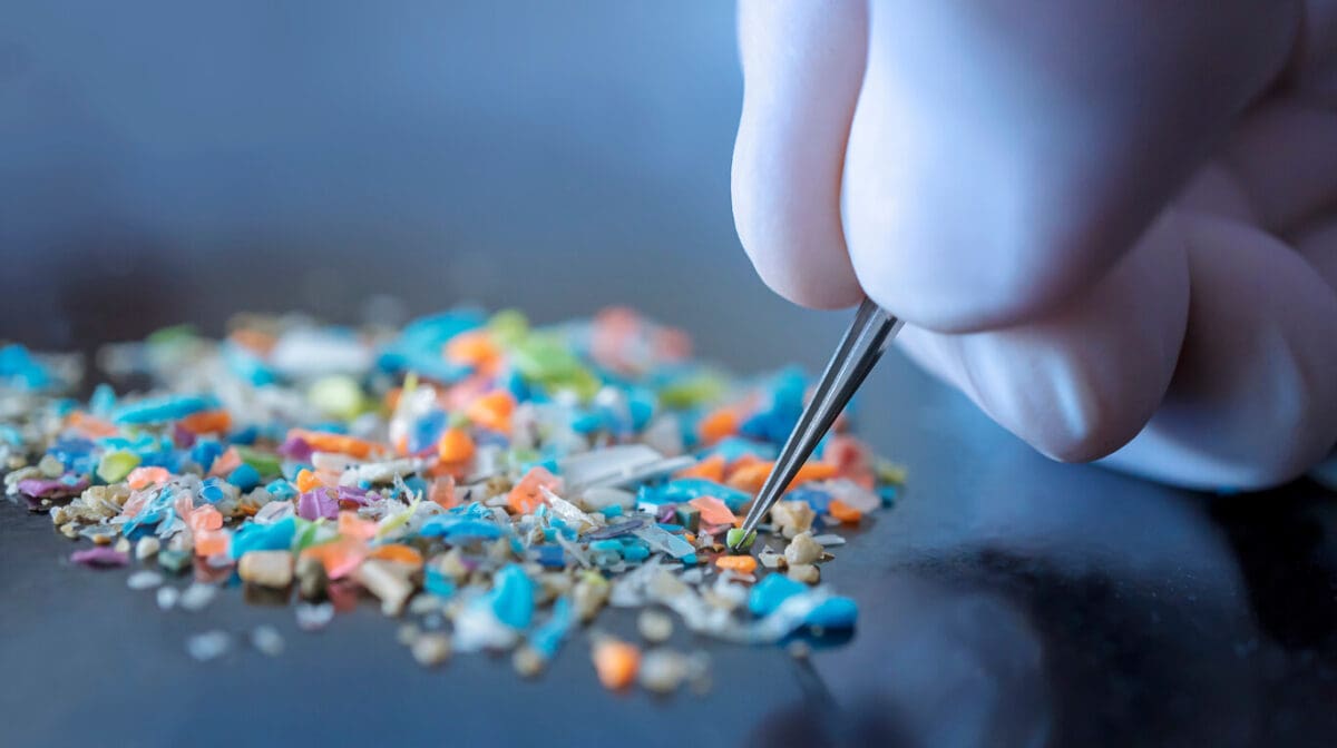 a scientist studying microplastics using a tweezer