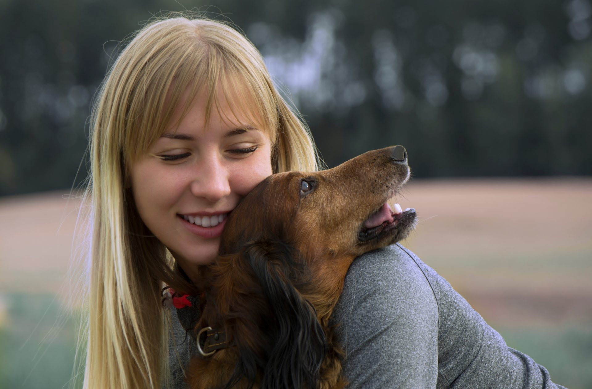 Woman hugs a dog.