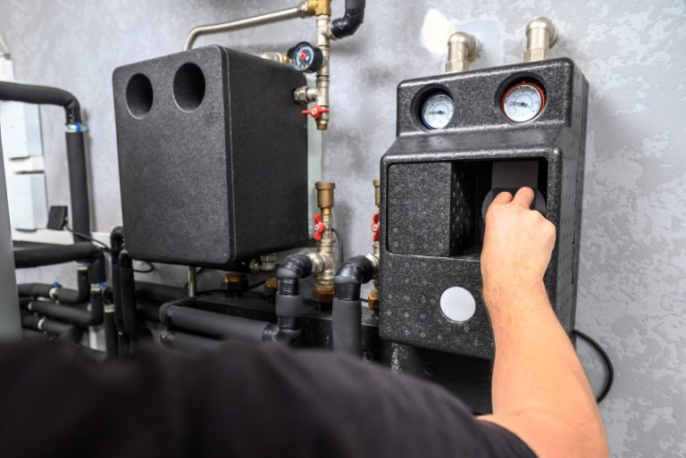Man in a modern electric boiler room.
