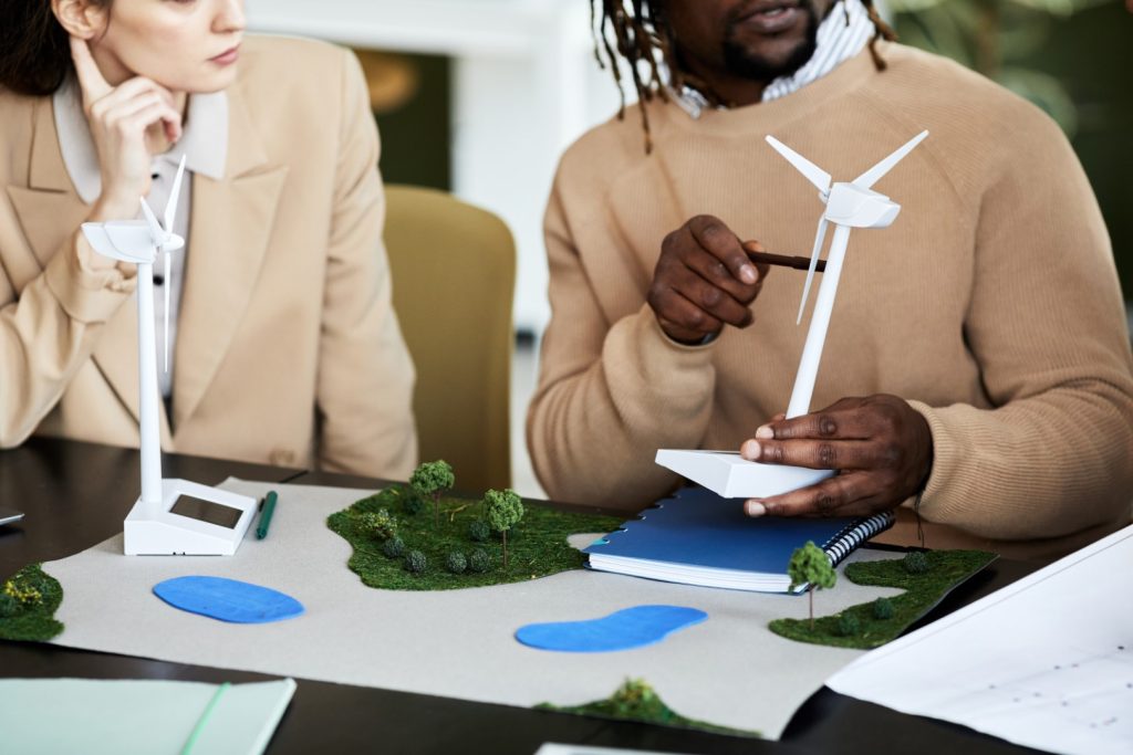 People discuss a sustainable project at a table.