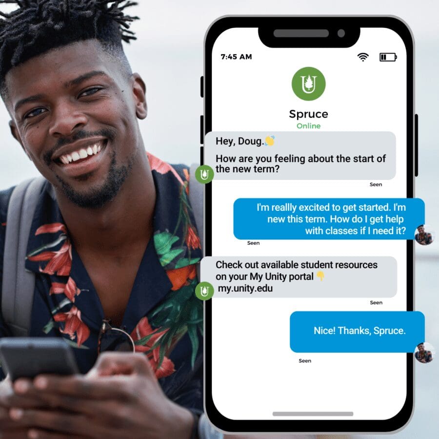 A young man wearing a black and floral shirt smiles at the camera while holding his phone with messages from Spruce.