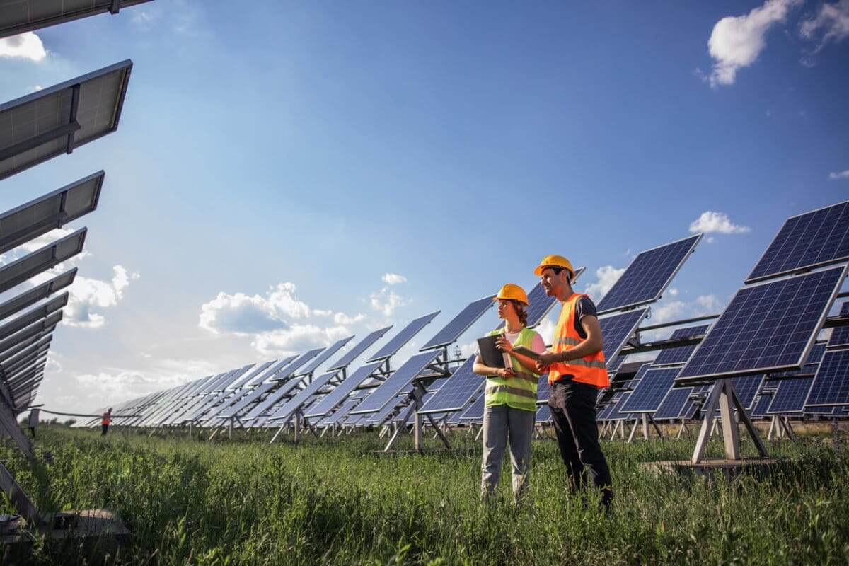two solar engineers inspecting a solar plant