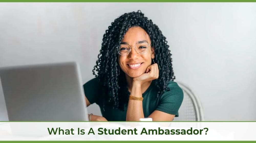 a student ambassador for a university sitting at a computer