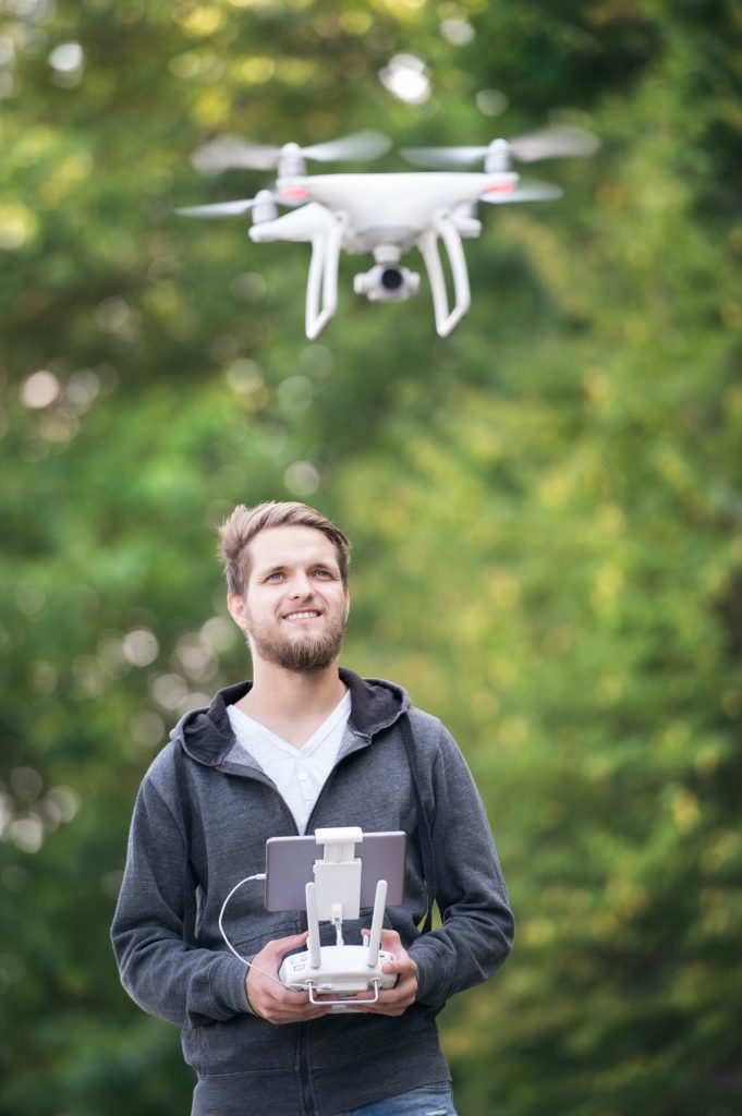 young-hipster-man-with-flying-drone-sunny-green-n-2024-10-18-08-50-12-utc (1)