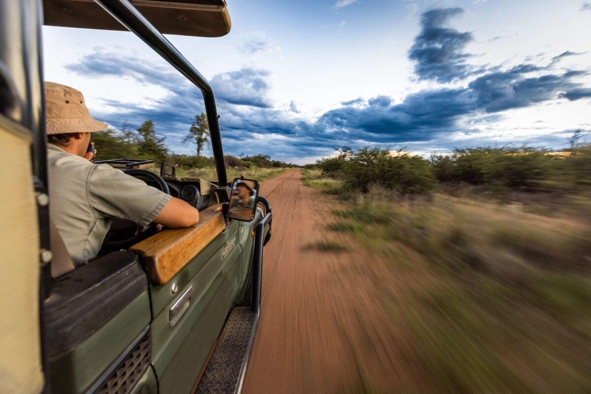 a conservation law enforcement officer driving out to catch poachers in a desert environment