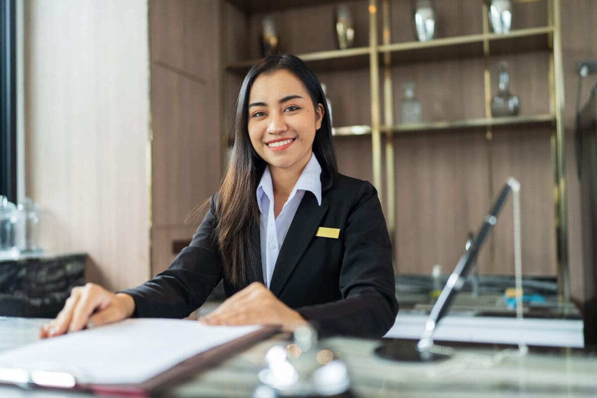 a hotel manager sitting at a desk with a clipboard