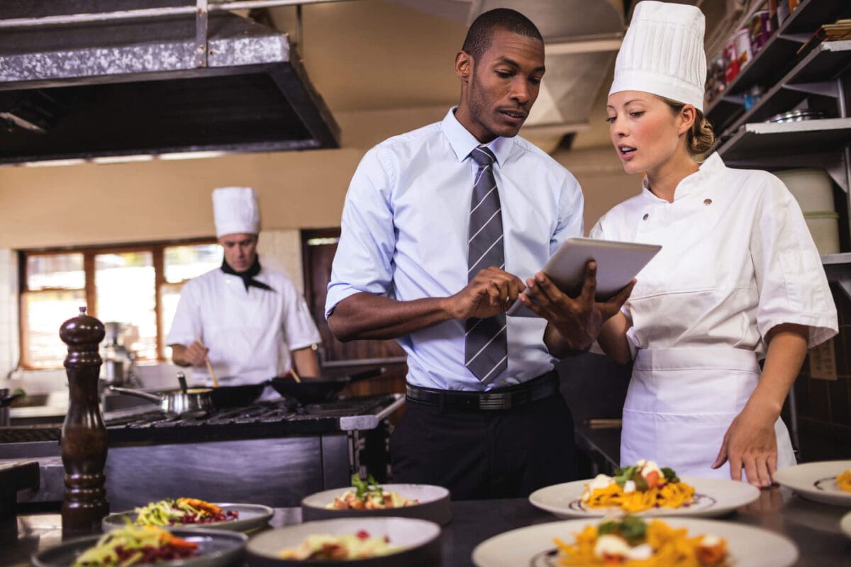 a restaurant manager talking with a chef