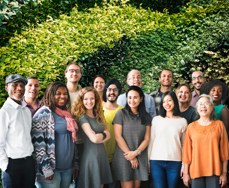 a-team-of-diverse-people-doing-a-group-photo–living-wall