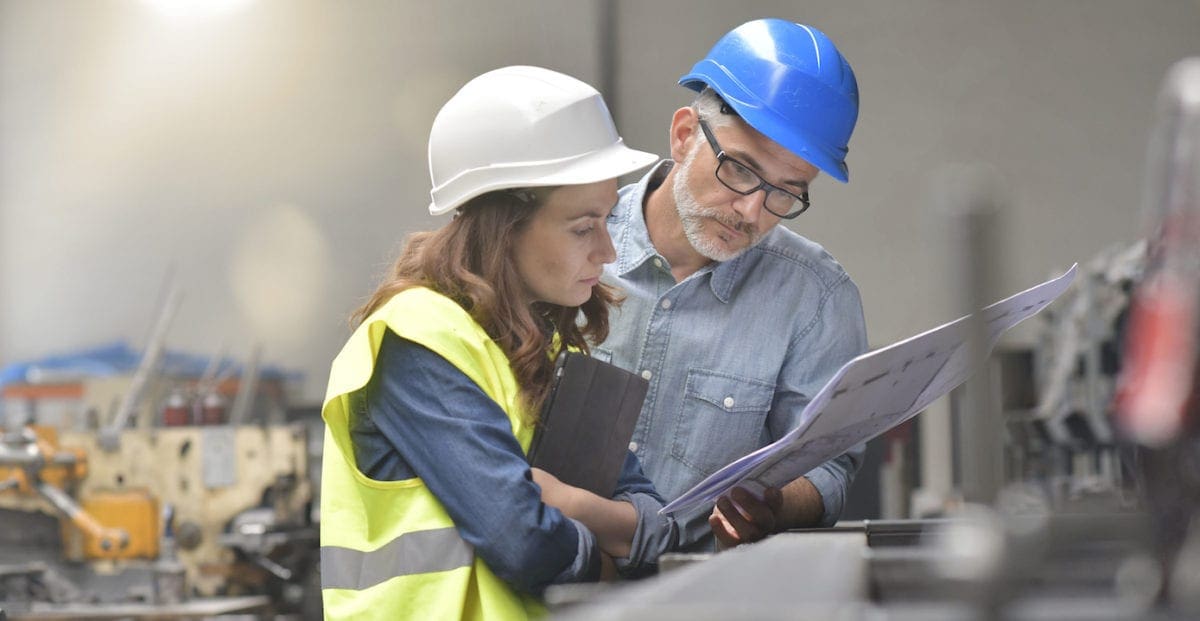 a sustainable manager checking an employee's work