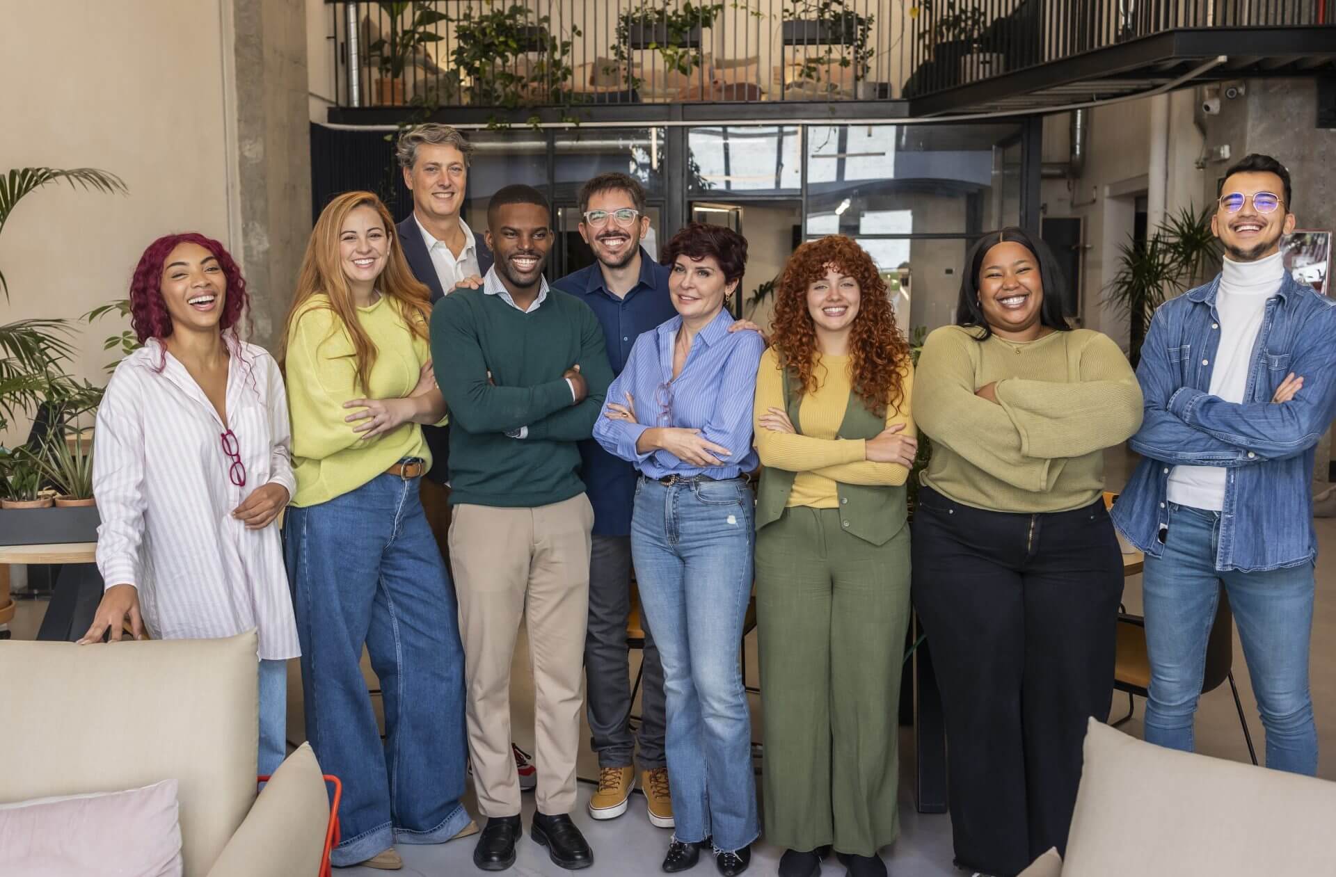 startup-team-smiling-with-folded-arms-in-modern-