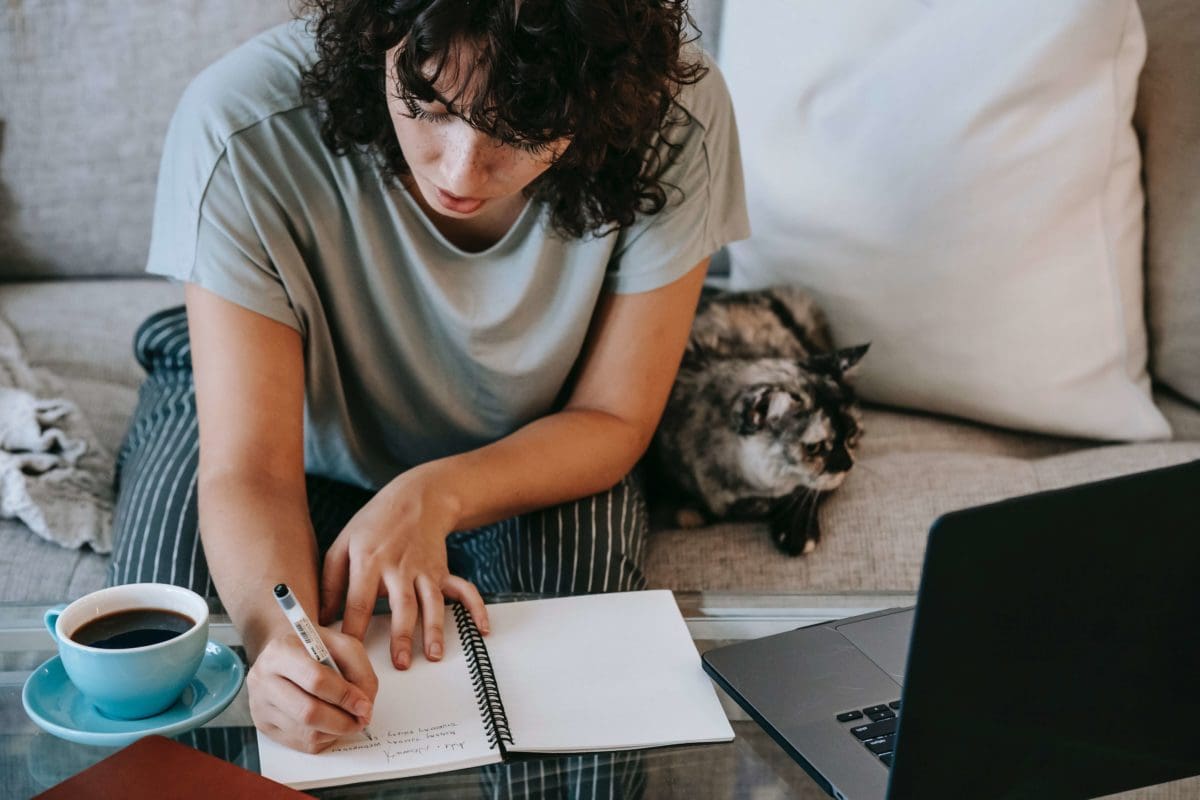 vet-tech-student-studying-at-home-with-pet