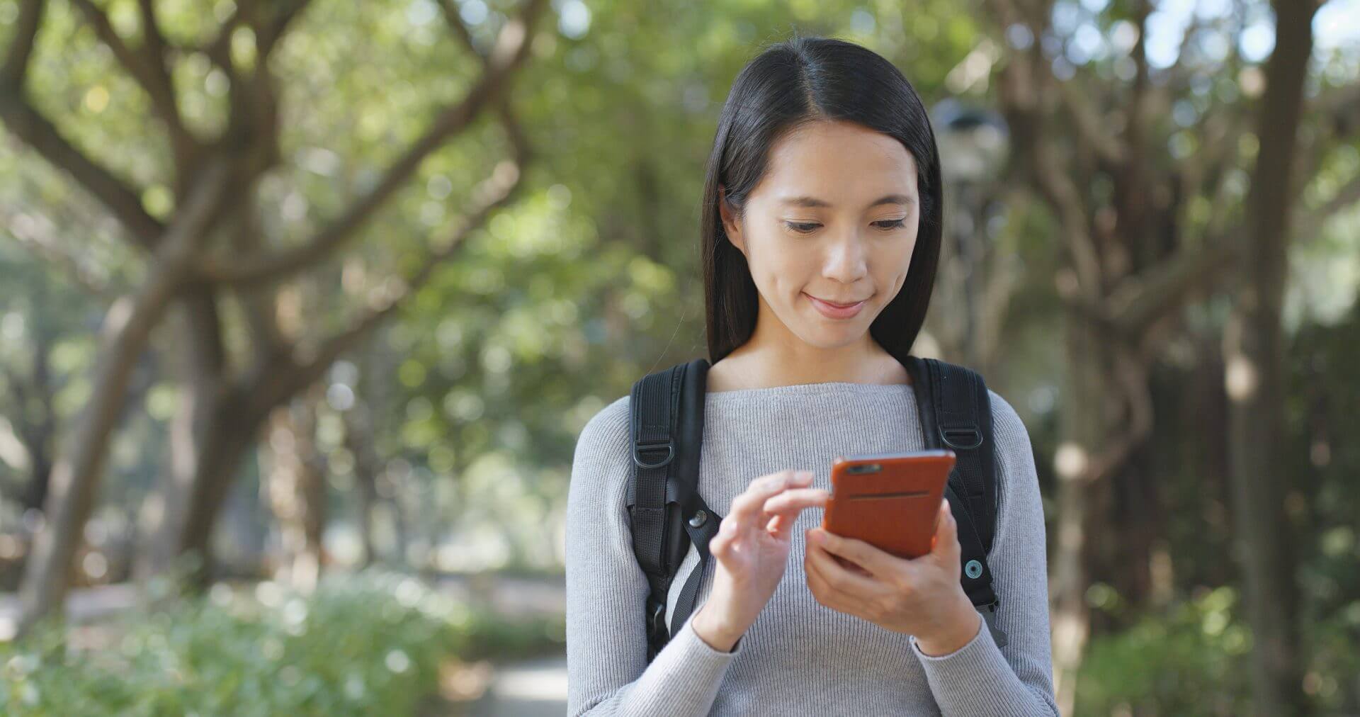 woman-using-smart-phone-at-outdoor-2025-03-26-05-07-07-utc