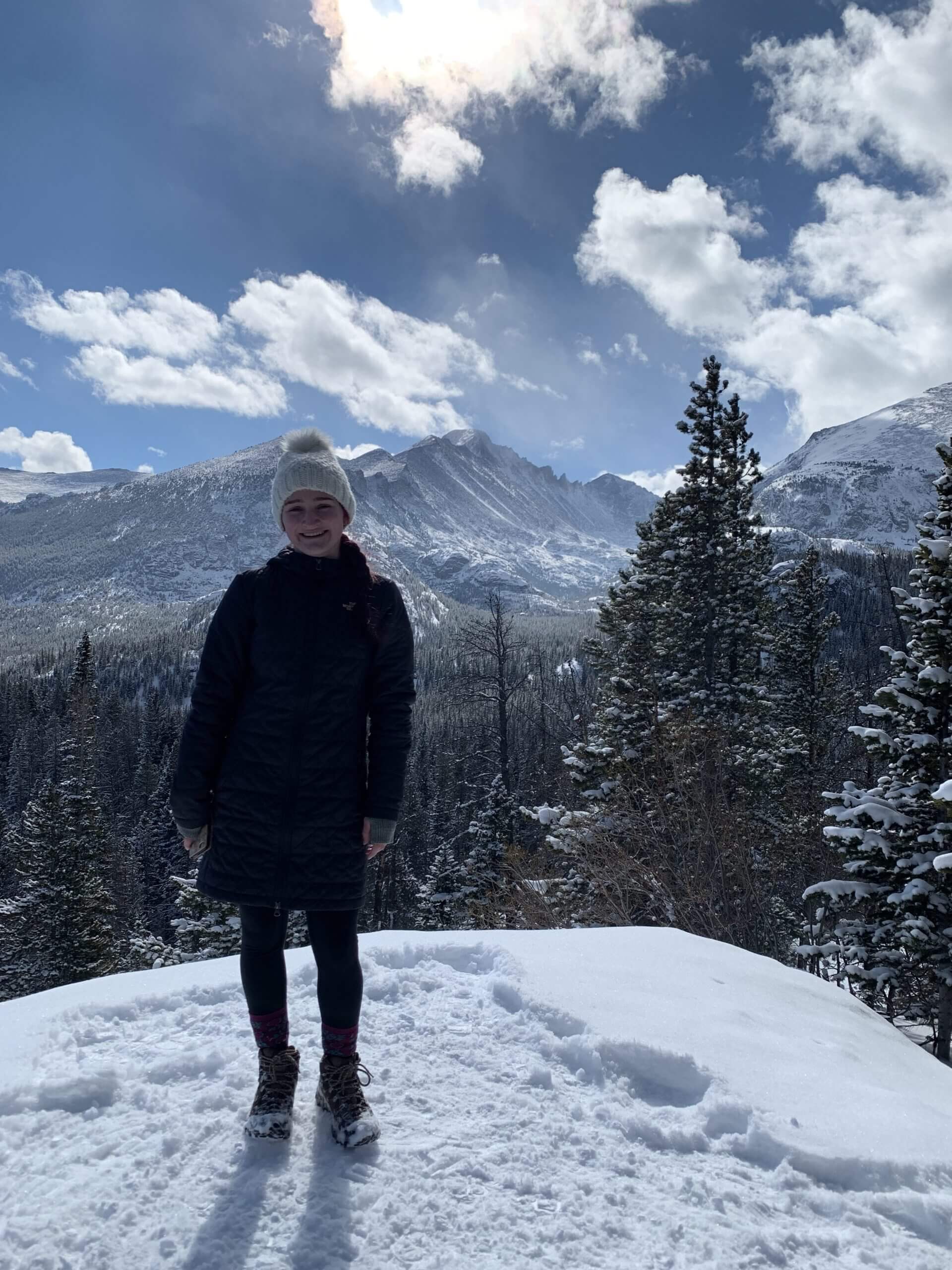 DE student Brianna posing on a snowy mountain.