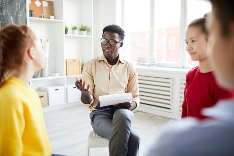 Man leads a discussion group.