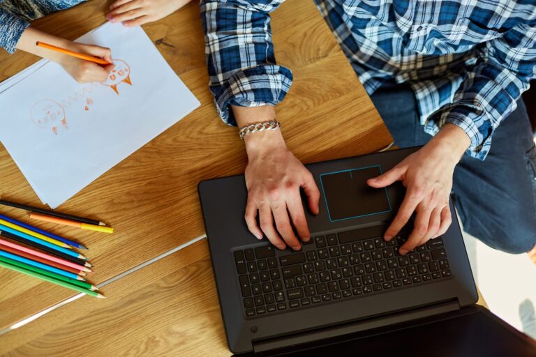 top-view-of-father-working-in-his-home-office