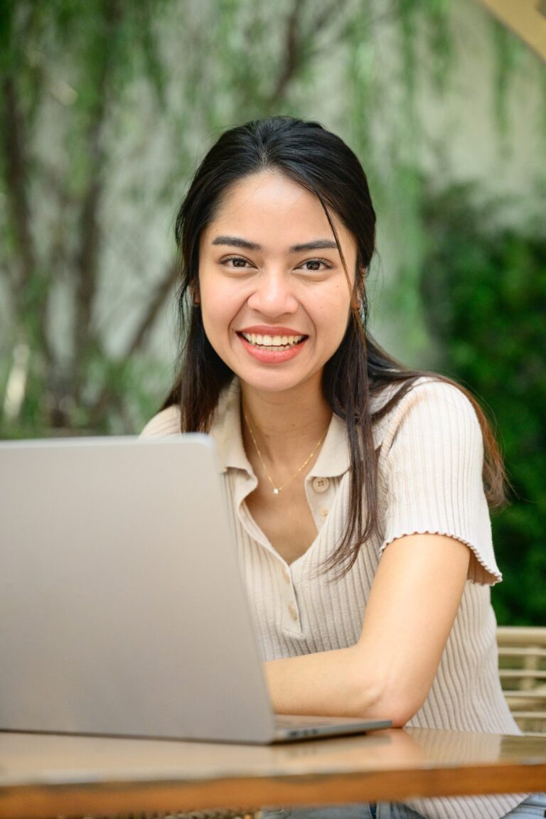young-asian-freelancer-smiling-and-working-on-laptop
