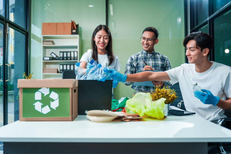 In an office, an Asian team discusses waste management strategie