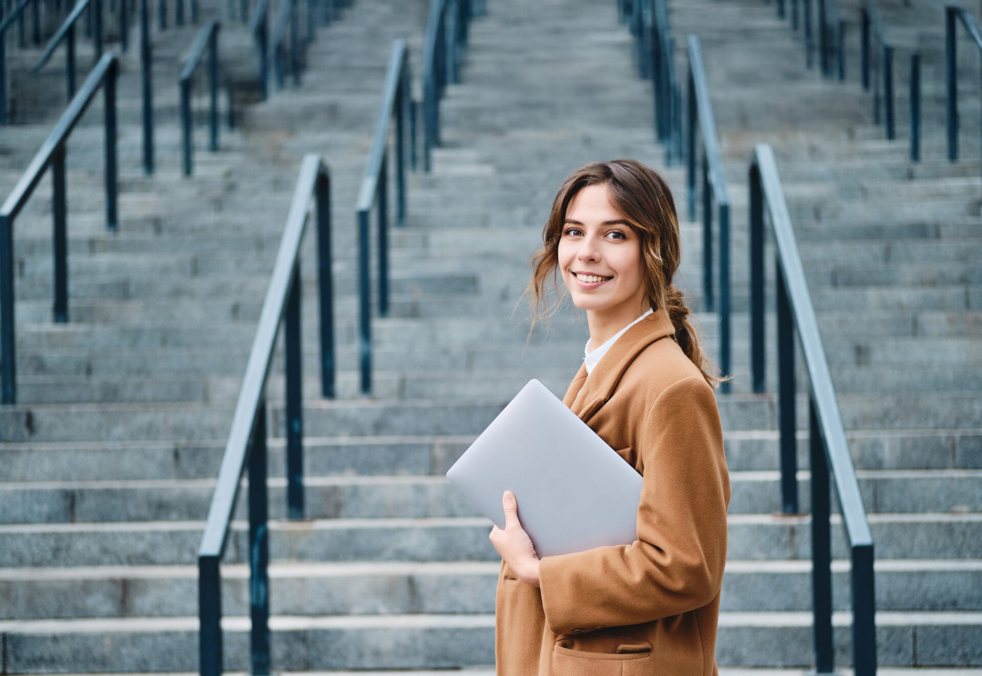 businesswoman-in-coat-with-laptop-full