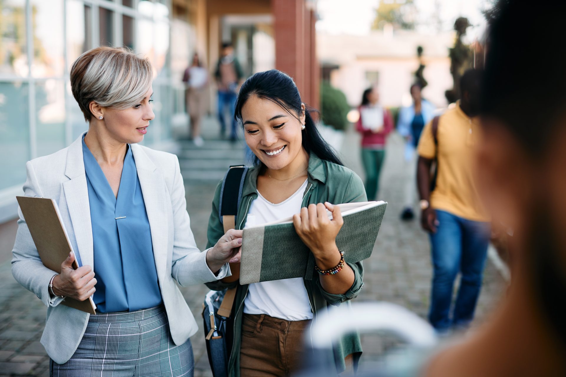 university-teacher-talking-to-her-asian-female-stu-2026-01-06-10-27-25-utc-flipped