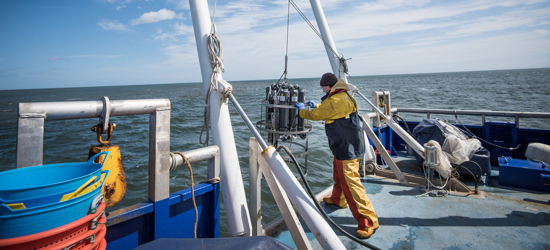 scientist-lowering-sea-water-sampling-experiment